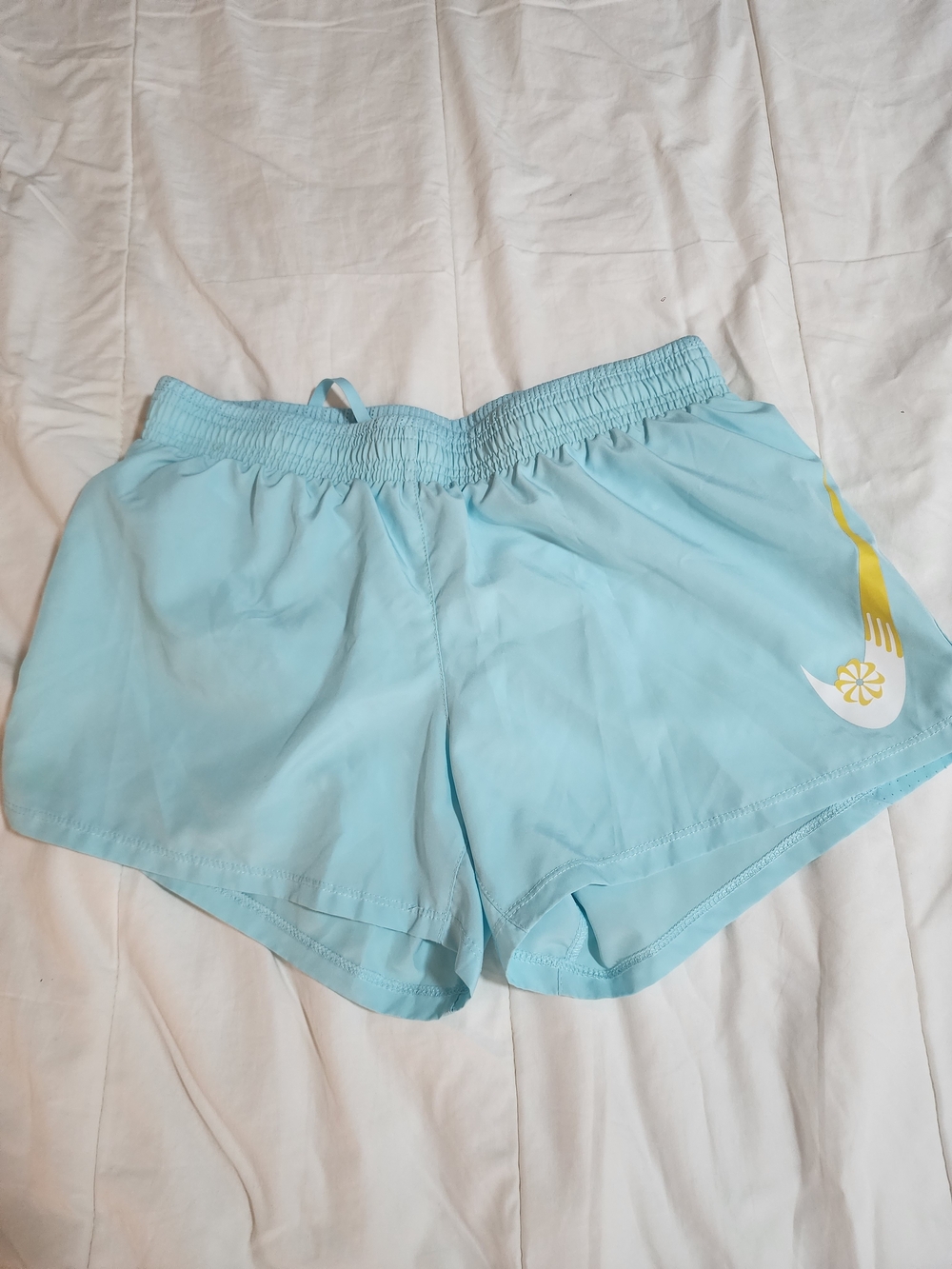 Nike Women’s Light Blue Athletic Shorts with Yellow Swoosh Accent